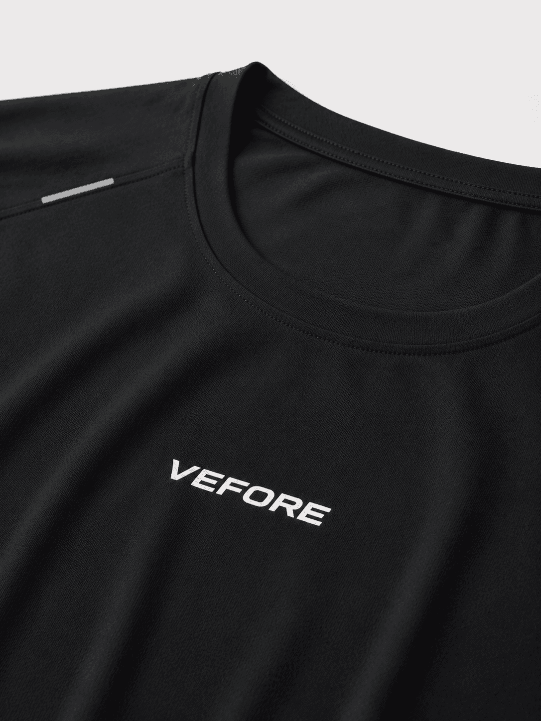 Close-up inspection detail of a finished black VEFORE garment